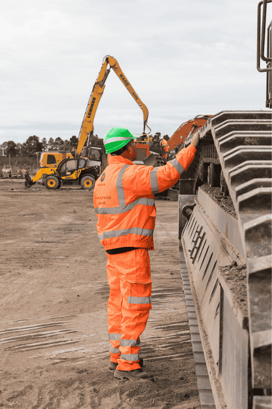 Engineer performing hydraulic maintenance to prevent machinery downtime.